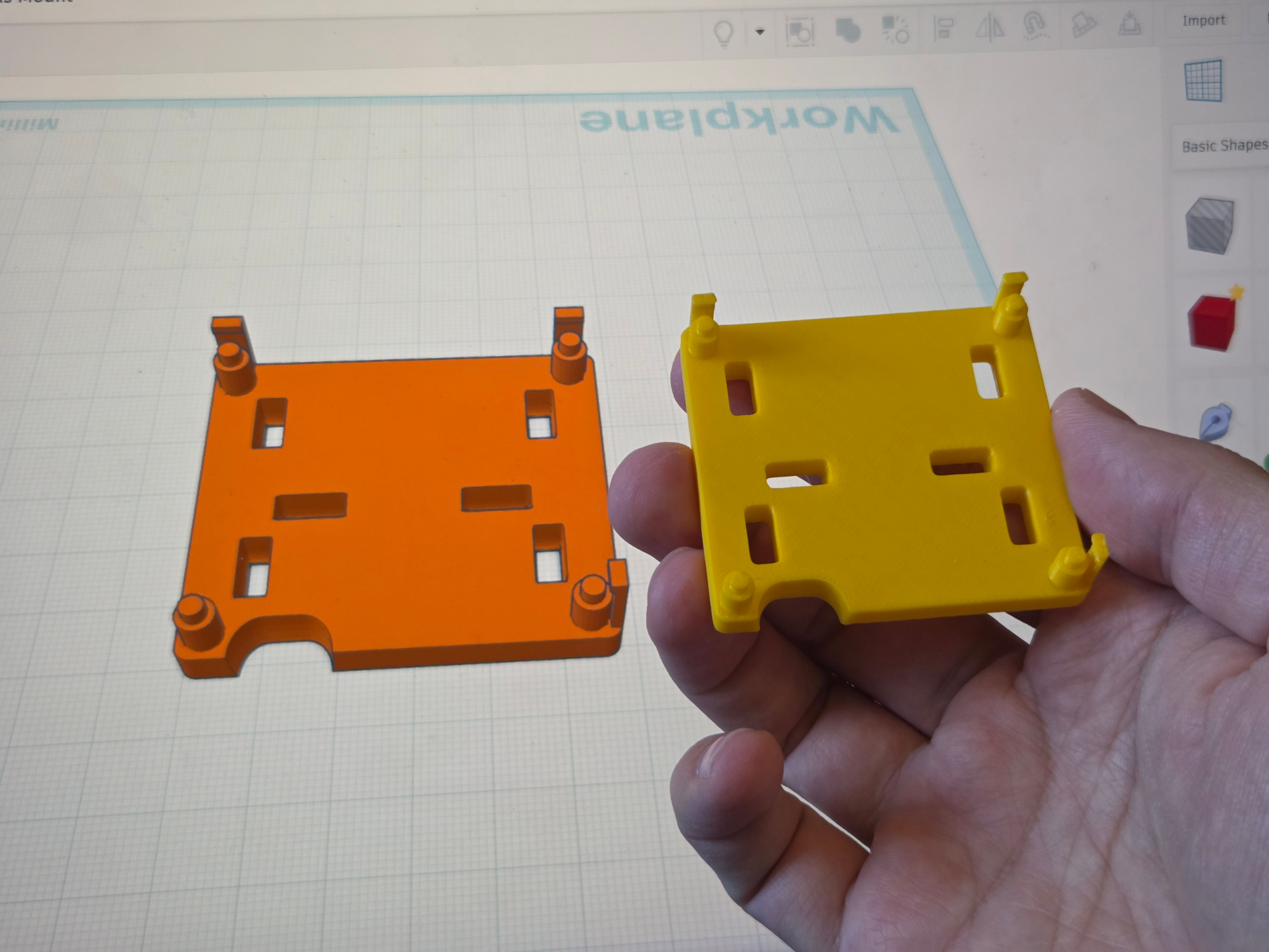 Side-by-side image of 3D render in Tinkercad and actual printed object in hand