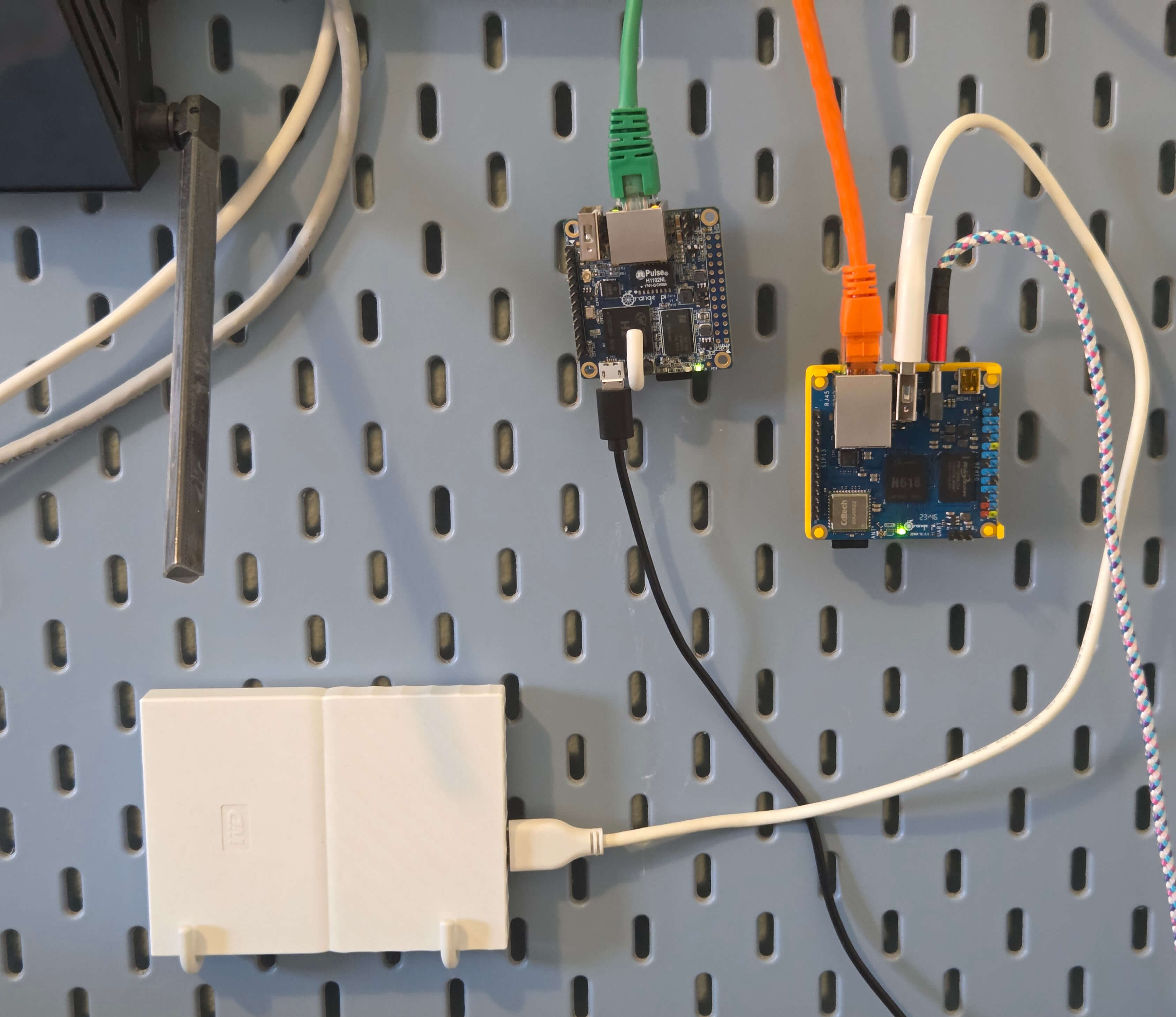 Image of a Orange Pi Zero 3 with white hard drive connected to it