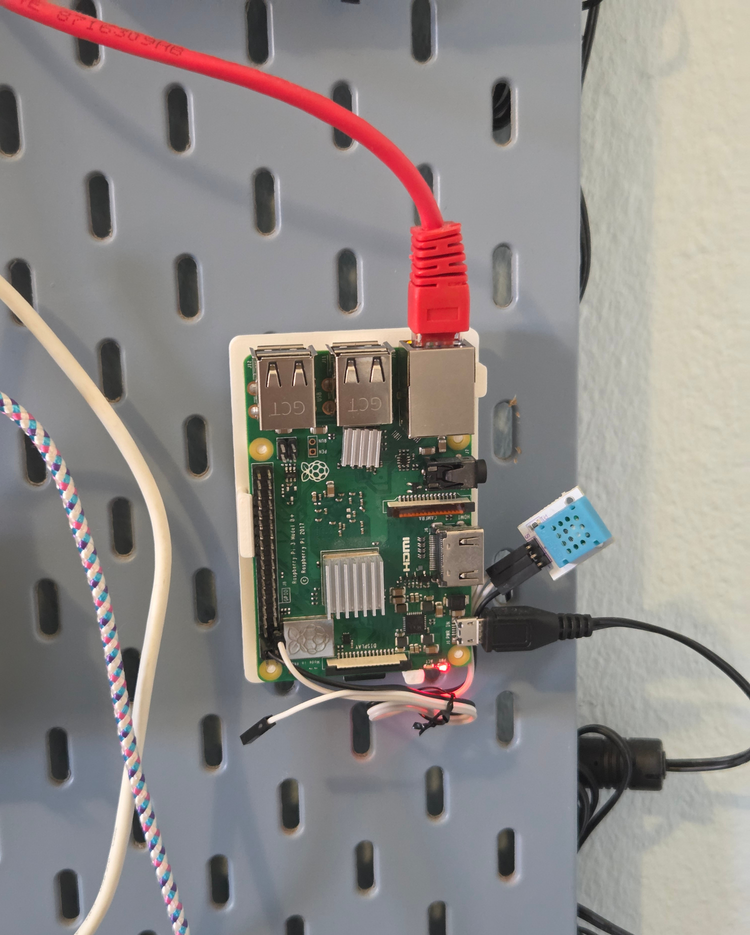Image showing a Raspberry Pi with a red ethernet cable connected to it