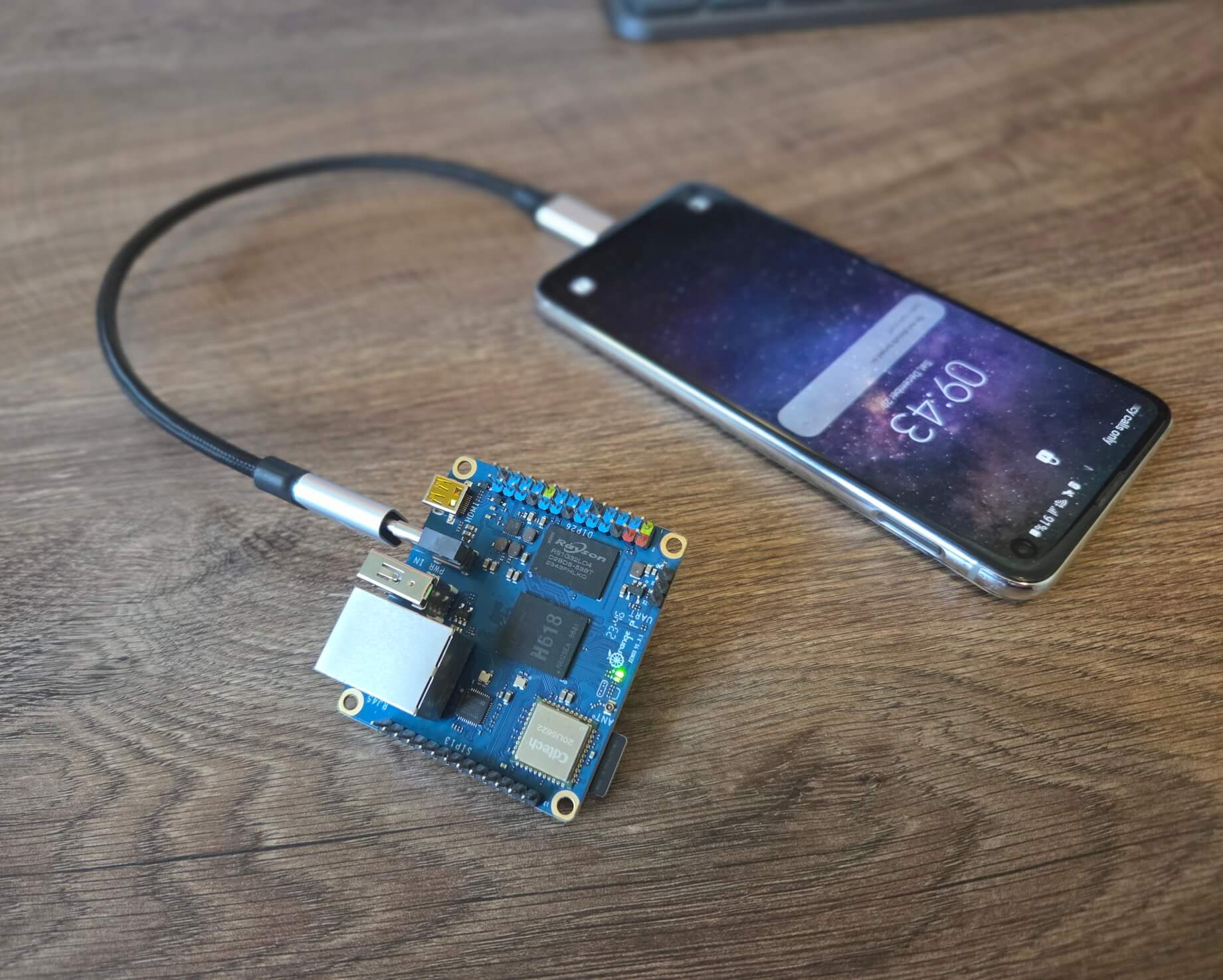 Image showing Orange Pi Zero 3 powered with USB cable running from Samsung phone